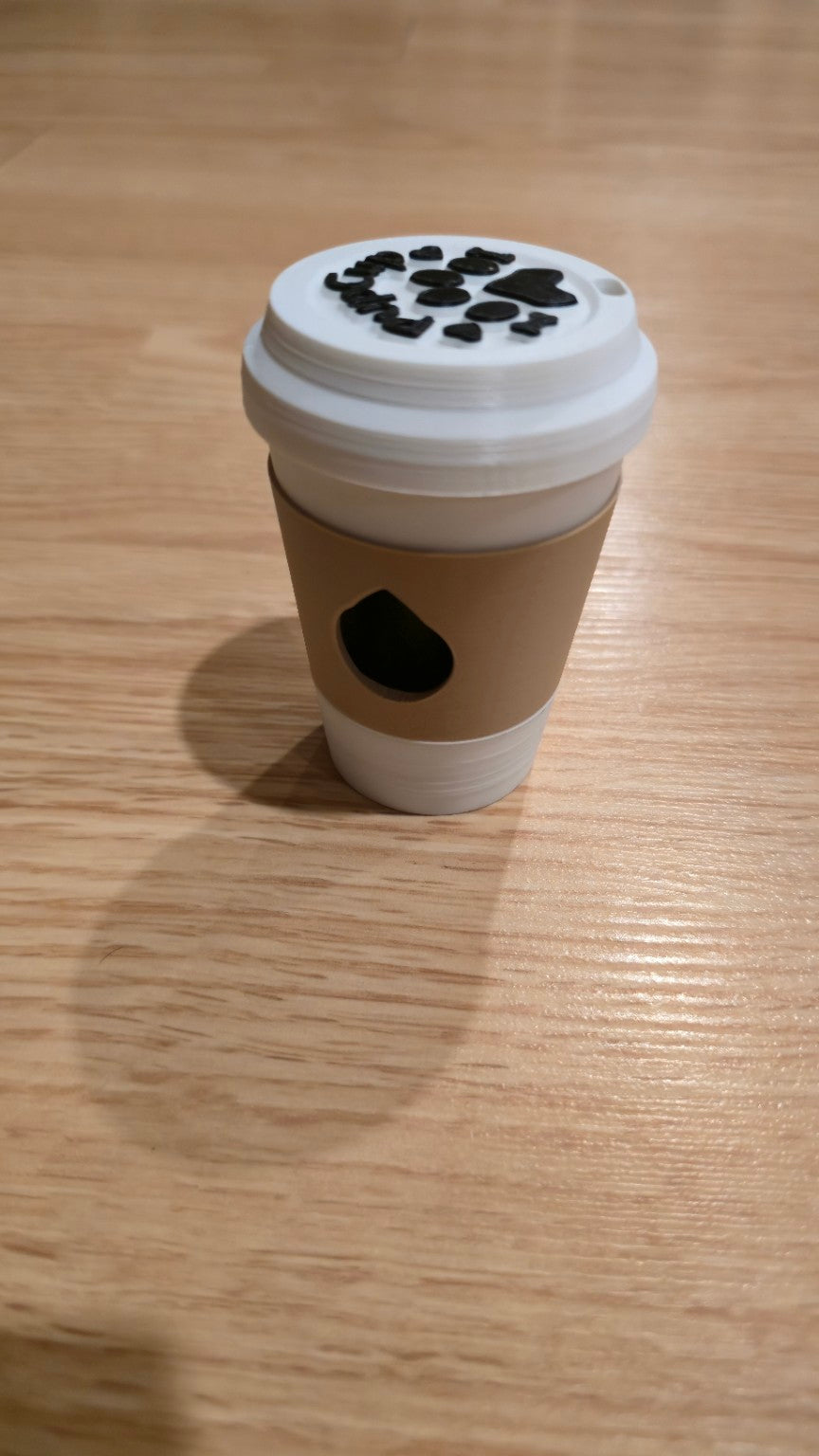 Light brown coffee cup dog waste bag holder with white lid