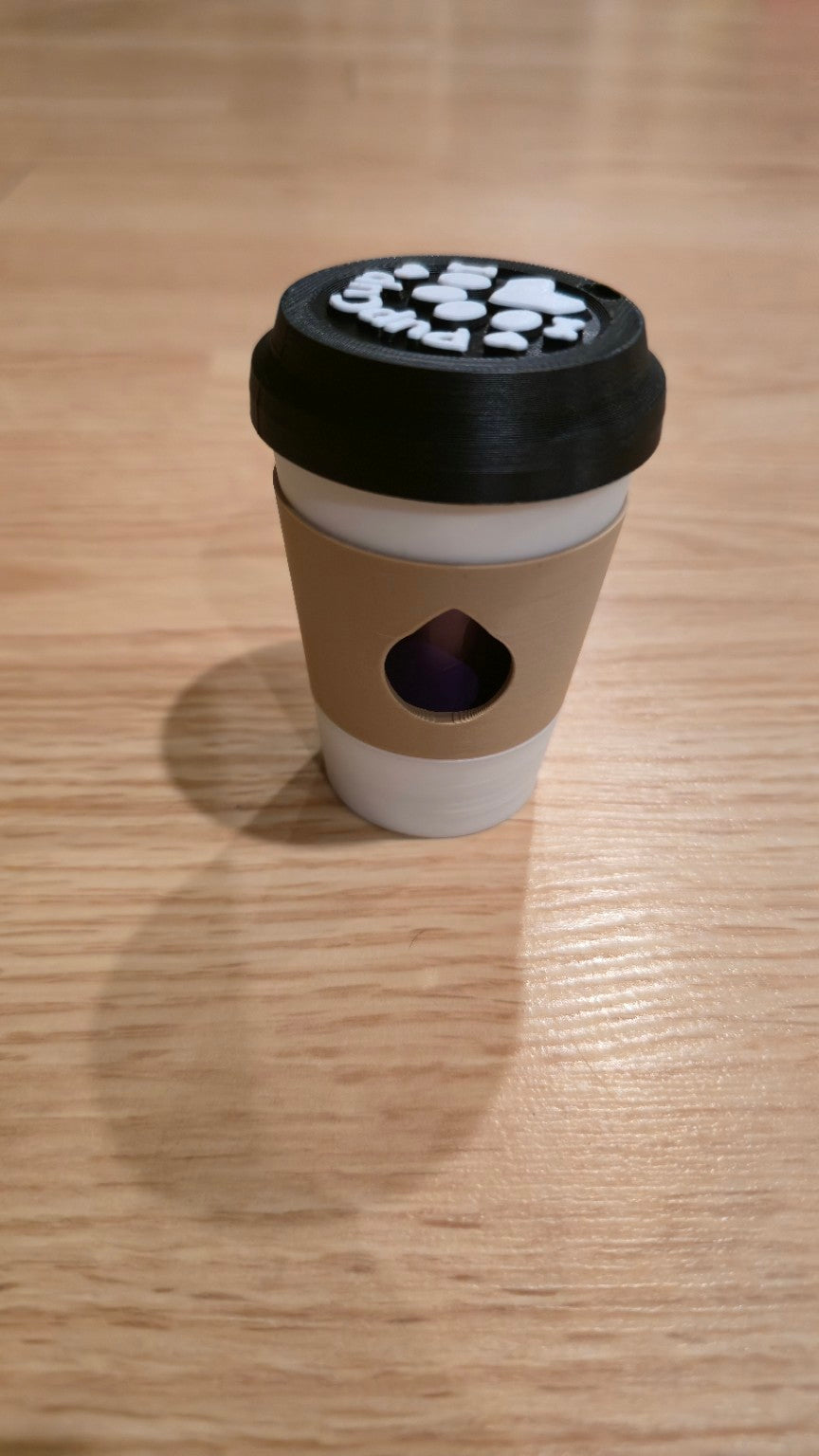 Light brown coffee cup dog waste bag holder with black lid
