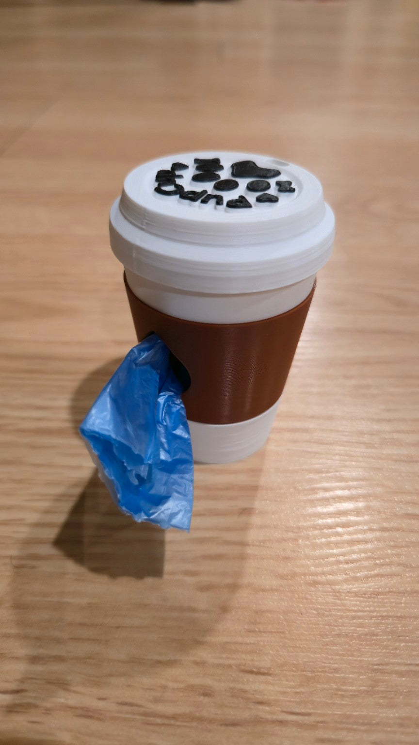Brown coffee cup dog waste bag holder with white lid dispensing a bag