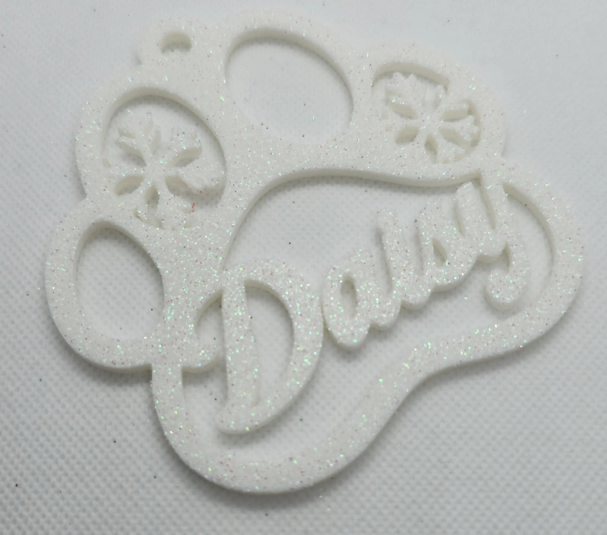 White paw print ornament with glitter and pet name